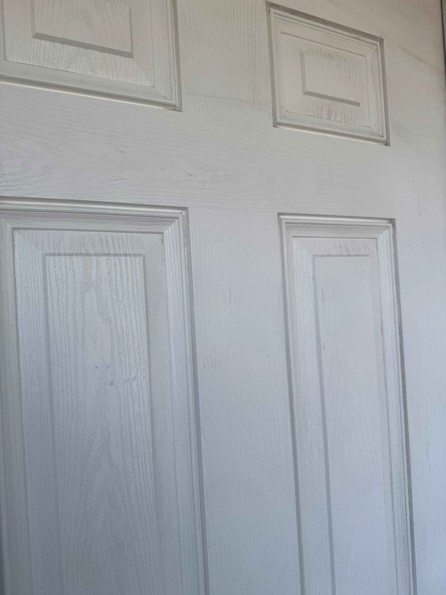 The same white paneled door after cleaning