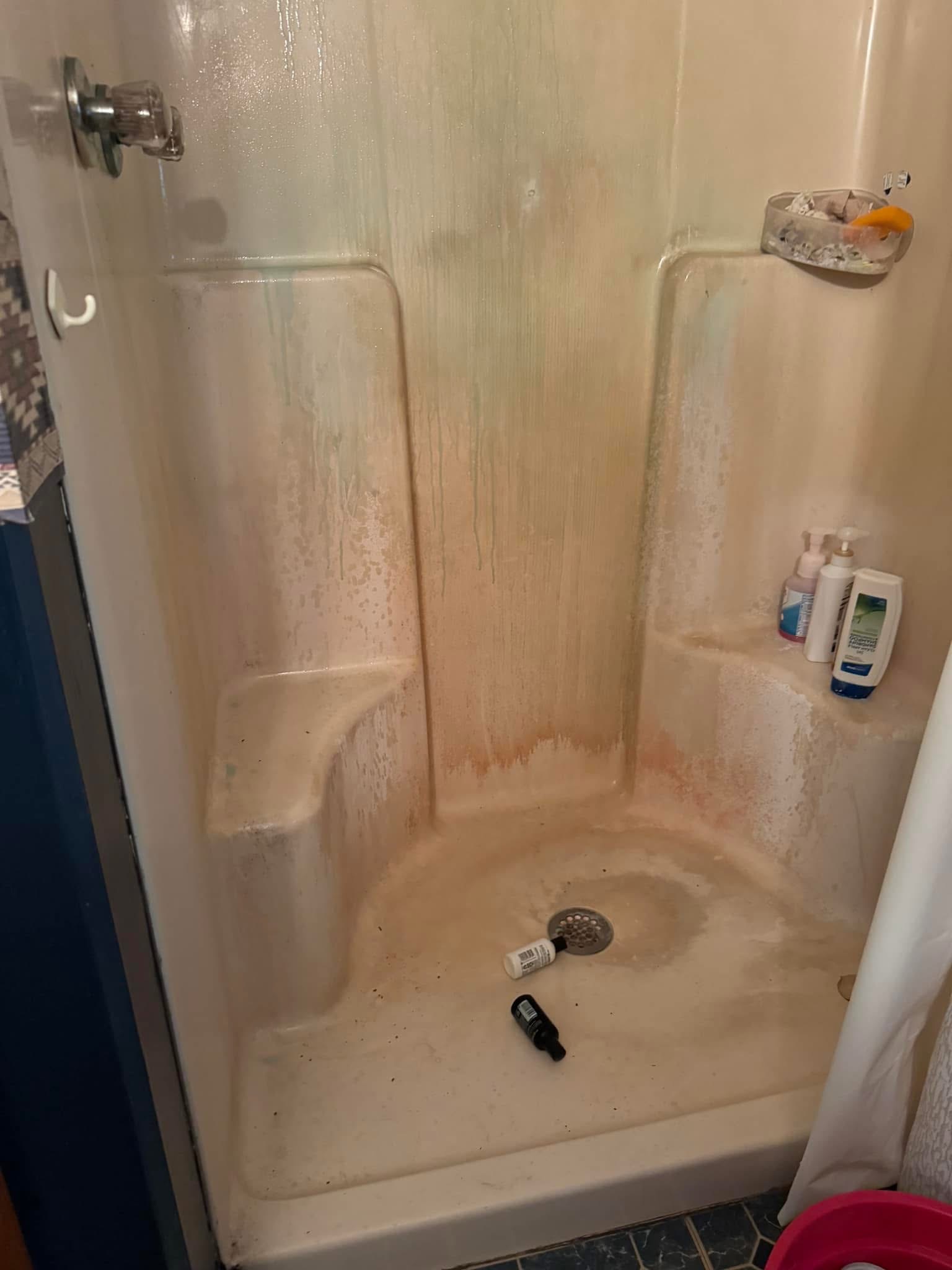 Shower with heavy soap residue before cleaning