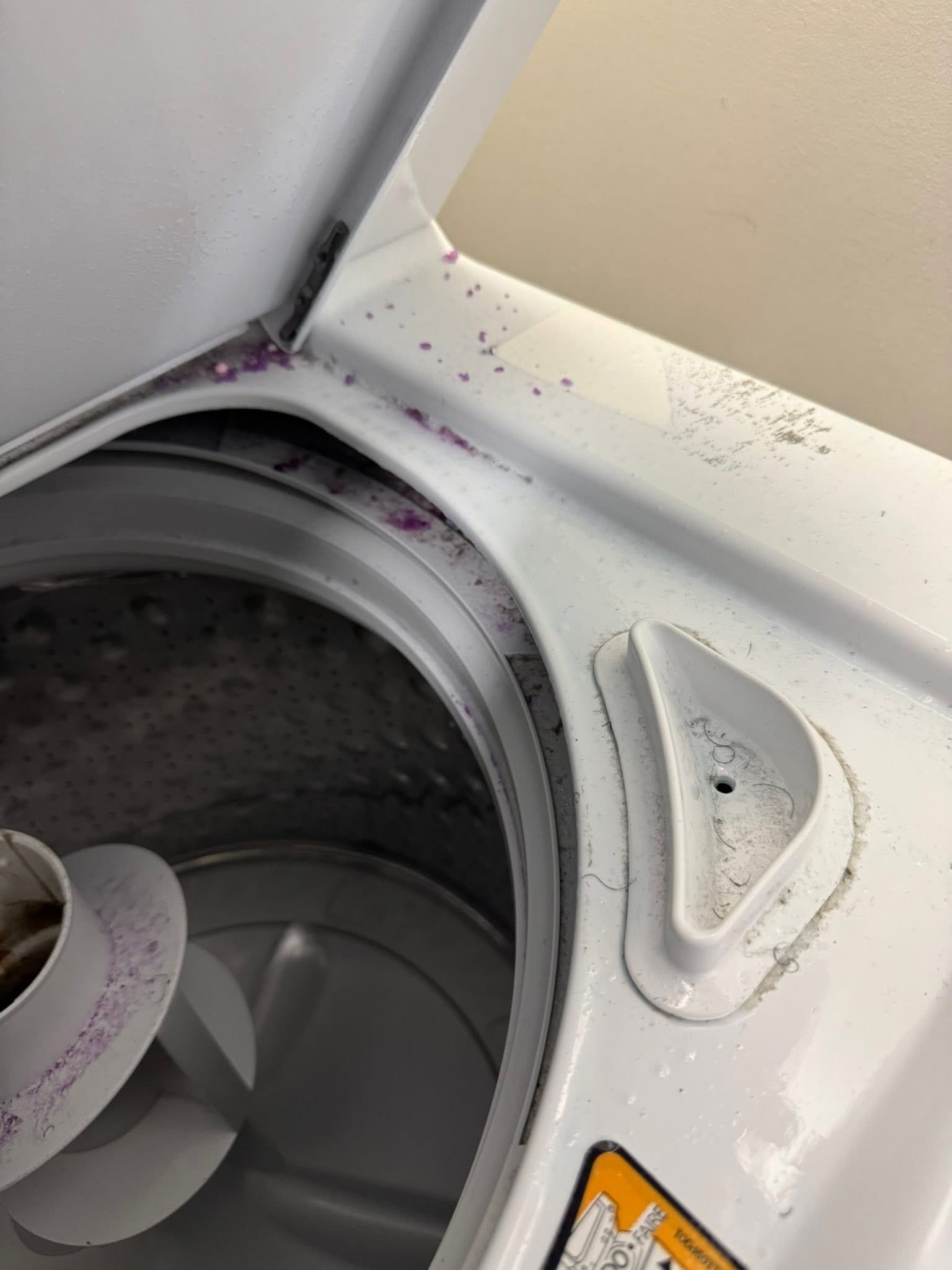 Washing machine rim with detergent residue before cleaning