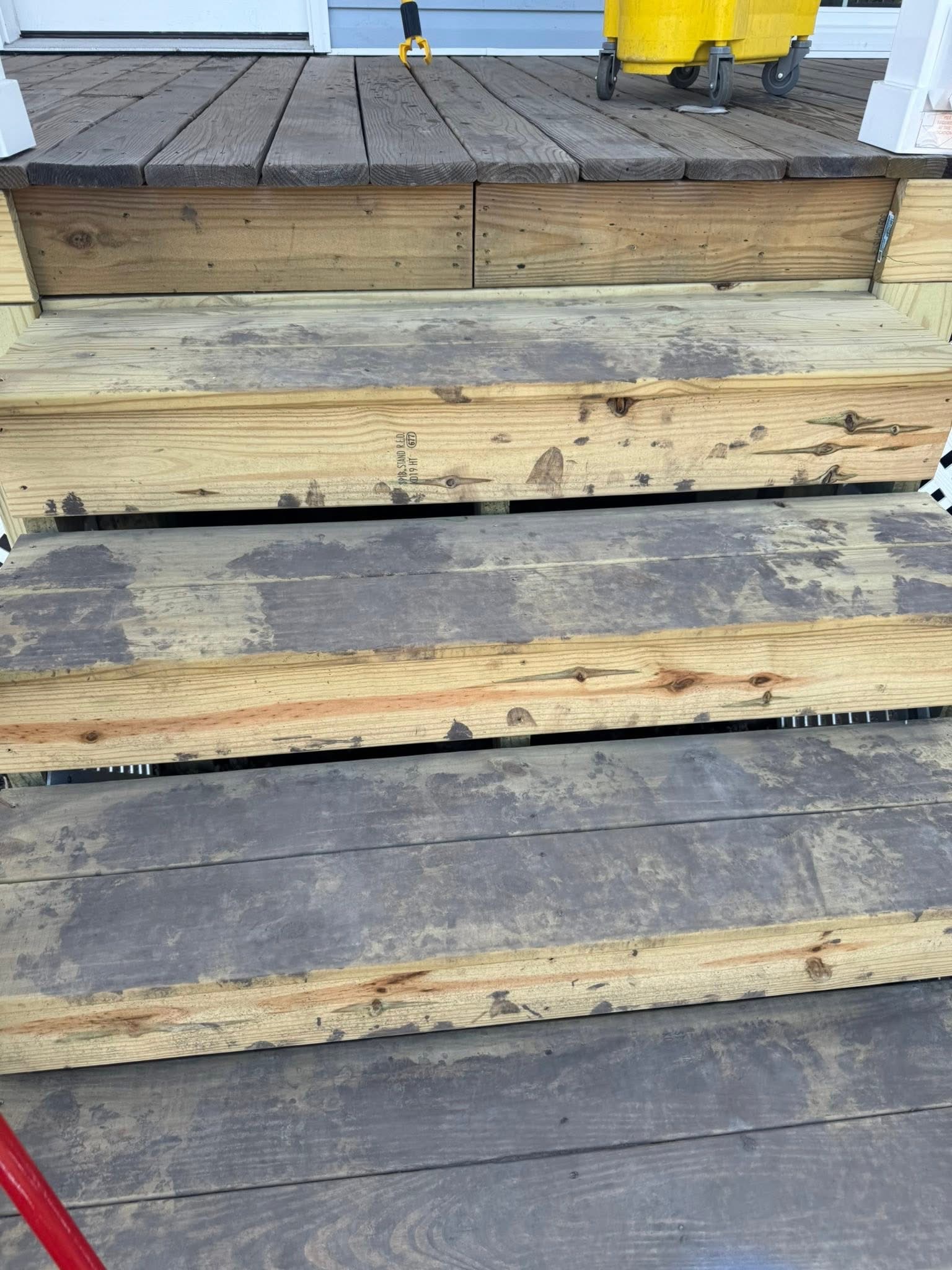 Exterior wood steps with heavy surface buildup before cleaning
